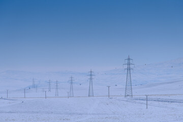 Electricity pylons and power lines, winter electrical malfunctions. high voltage post. High-voltage...