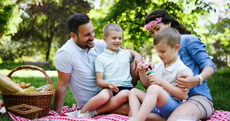 Fototapeta premium Cheerful happy family picnicking on a beautiful day