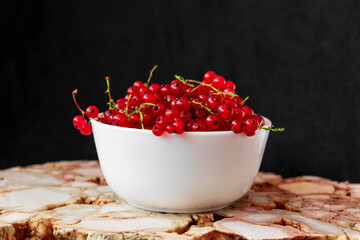 Fresh, ripe red currant in a white bowl