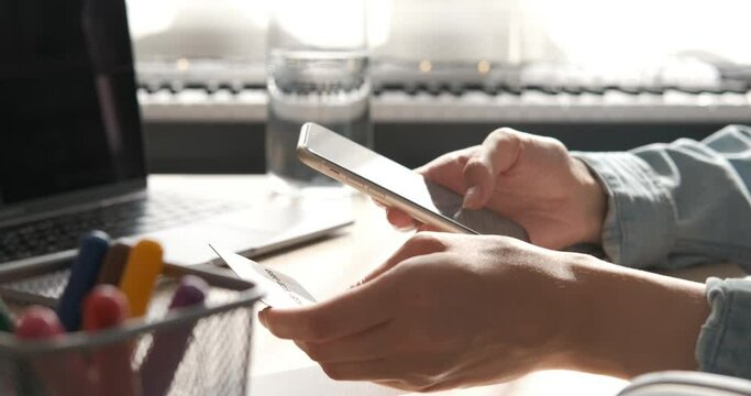 Online banking with smart phone. Lifestyle. Easy pay using smart phone or digital device. Communication via app for sale in shop. Woman shopping online on a sunny day with credit card. Hands close up
