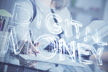 Cryptocurrency hologram over woman's hands writing background. Concept of blockchain. Double...
