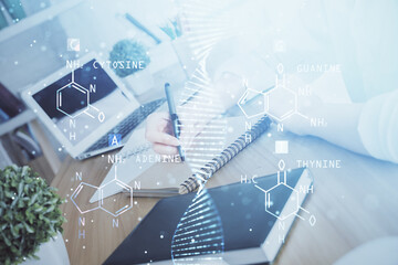 DNA theme hologram over woman's hands writing background. Concept of education. Double exposure