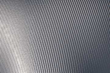 Close up of grey carbon fiber pattern texture surface.
