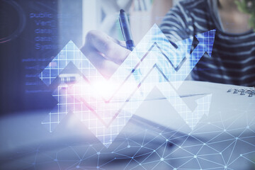 Blue arrow over woman's hands taking notes background. Concept of success. Double exposure