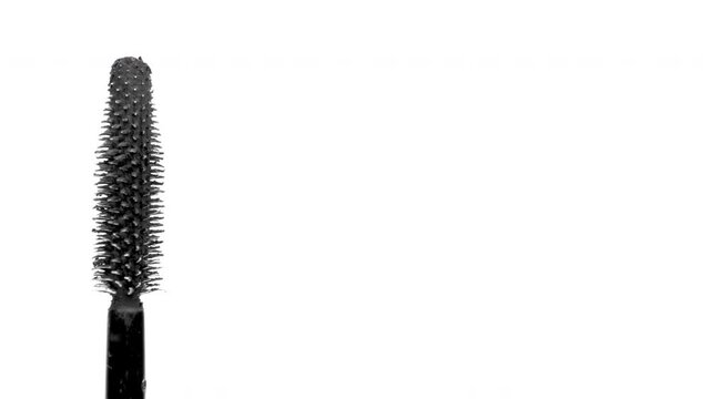 black mascara moving around on white background 
