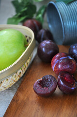 Piece of Juicy Plum on Wooden Board
