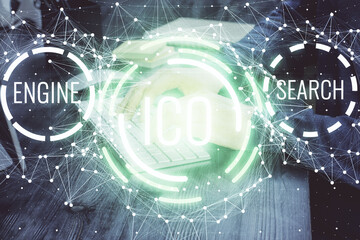 Crypto currency theme hologram with businessman working on computer on background. Concept of...