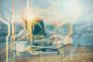 Double exposure of world map hologram with man working on computer on background. Concept of worldwideweb.