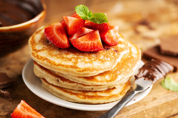 Freshmade pancakes served with strawberry and choco paste