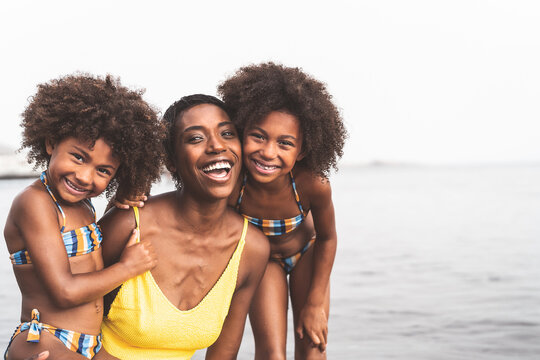 Happy African Family On The Beach During Summer Holidays - Afro American People Having Fun On Vacation Time - Parents Love And Travel Lifestyle Concept