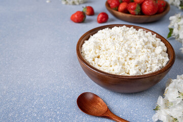 cottage cheese with strawberries in a wooden bowl. Healthy breakfast