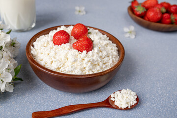 cottage cheese with strawberries in a wooden bowl. Healthy breakfast