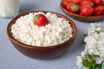 cottage cheese with strawberries in a wooden bowl. Healthy breakfast
