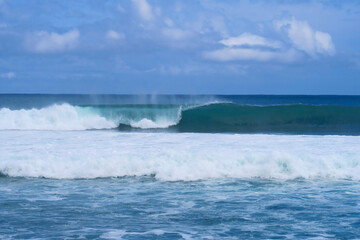 Naklejka premium Blue closing surfing wave at popular surf beach Balangan in Bali island, Indonesia