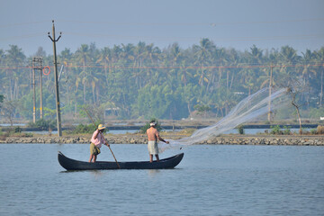 A fisherman throwing net to catch fish.