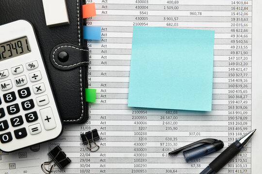 Top view of office employee's desk - work with financial reports, analysis and accounting, tables and graphs, various office items for bookkeeping