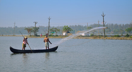 A fisherman throwing net to catch fish.