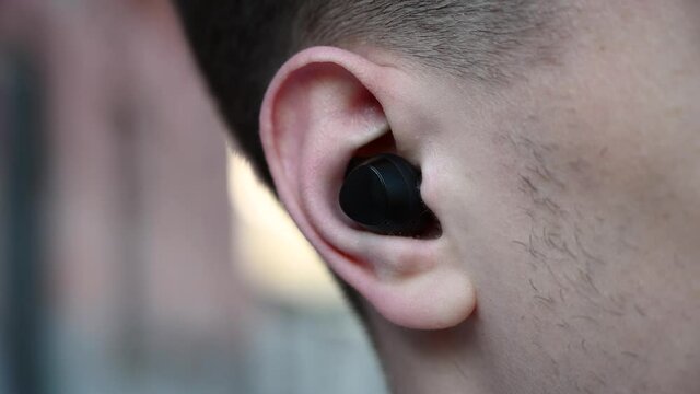 Man testing black earbuds