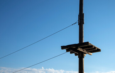empty wooden pole and wires in an outdoor activity park