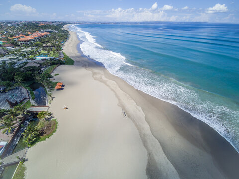 Absolutely empty Petitenget Beach (Pantai Petitenget) closed for quarantine for COVID-19. Seminyak, one of Bali most popular tourist areas. Indonesia. Aerial drone image.
