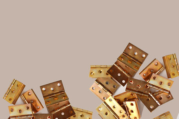furniture copper new hinges lie scattered on a beige background, a lot of details, furniture connections, furniture assembly concept, handmade, hobby