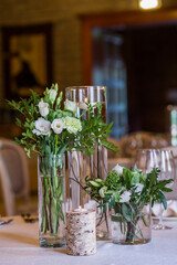 
Banquet table with green floristry.
