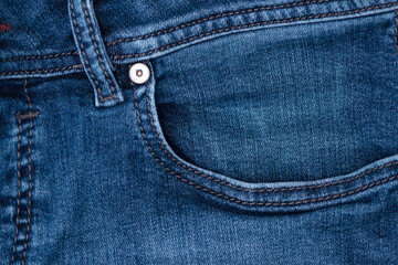 close view of a blue denim stone washed jean pocket
