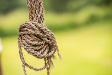 Remains of a rope monkey fist hanging in a harden.