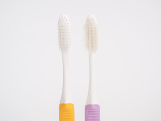 Comparison Concepts. Old used and new pastel toothbrush comparison on white background .