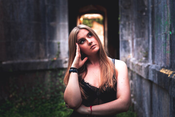 Fototapeta premium Young girl posing in old ruins.