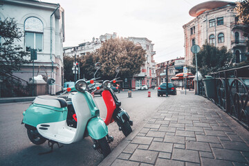 Two moped scooter in the street.