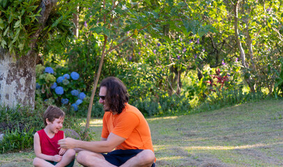 Uncle and nephew meditating and playing in nature.
