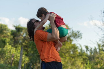 Uncle and nephew playing together in the middle of nature.