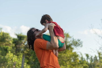 Uncle and nephew playing together in the middle of nature.
