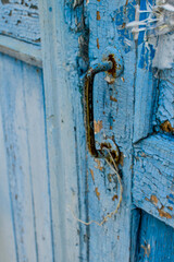 doorknob on an old blue wooden door.