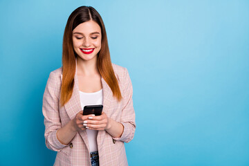 Fototapeta premium Portrait of positive cheerful girl ceo manager use smartphone read social network news repost subscribe share post wear checkered style blazer isolated over blue color background