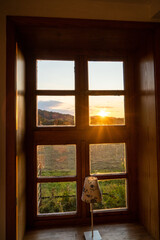 Sunset at lake house river through wooden window