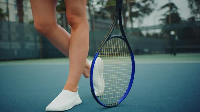Female tennis player swinging a ball while match, playing professional tennis, strained game