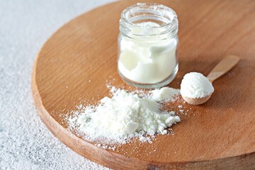 Collagen powder with on a light background. Extra protein intake. Natural beauty and health supplement for skin, bones, joints and gut. 