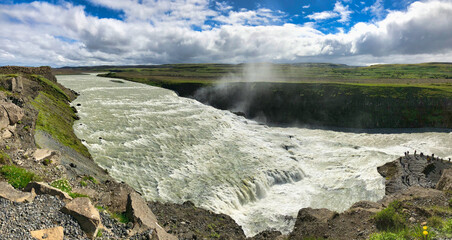 Top panoramic view of Gullfoss waterfall on the Hvítá river, a popular tourist attraction and part of the Golden Circle Tourist Route in Southwest Iceland. Golden Waterfall