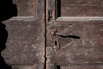 Old wooden door with rusty metal handle