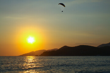 Small waves on the south coast of Turkey, a storm in the Mediterranean Sea, Oludeniz, Mugla, Fethiye. Rocky mountains that go to sea. National park, a popular tourist destination, sunset at sea