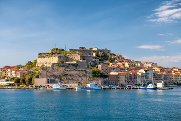 Fototapeta na wymiar PORTOFERRAIO, ITALY - JUNE 22, 2020: City buildings of Elba Island on a sunny day