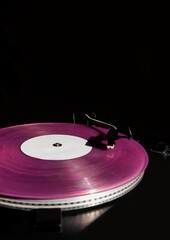 Vintage record player pink vinyl record black background old turntable