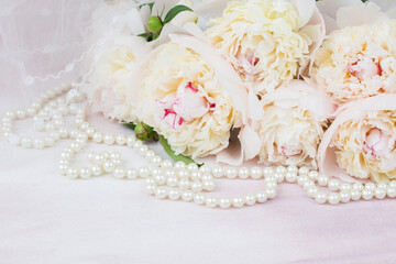 bouquet of white peonies, veil and pearl beads 