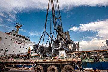 Cargo shipment of steel coil being loading or discharging by the workers stevedore man in the port...
