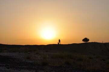 Naklejka na ściany i meble silhouette of a man on a sunset