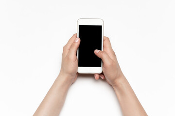 Close up of human hands using smartphone isolated on white background. Top view. Copyspace, blank screen. Surfing, online shopping, scrolling, betting, working. Education and business concept.