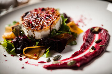 Grilled goat cheese salad Pickled beetroot pumkin, cranberry jam, pumkin seeds Delicious mediterranean traditional vegeterian food closeup served for lunch in modern cuisine gourmet restaurant