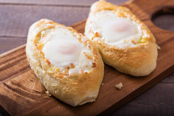 Khachapuri, open pie with chees and egg. Adjarian Khachapuri is a traditional Georgian dis. Street food.